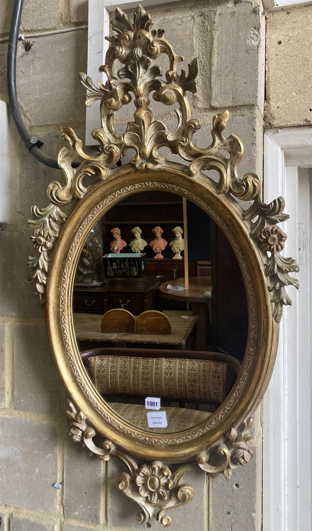 An oval giltwood wall mirror, width 59cm, height 103cm